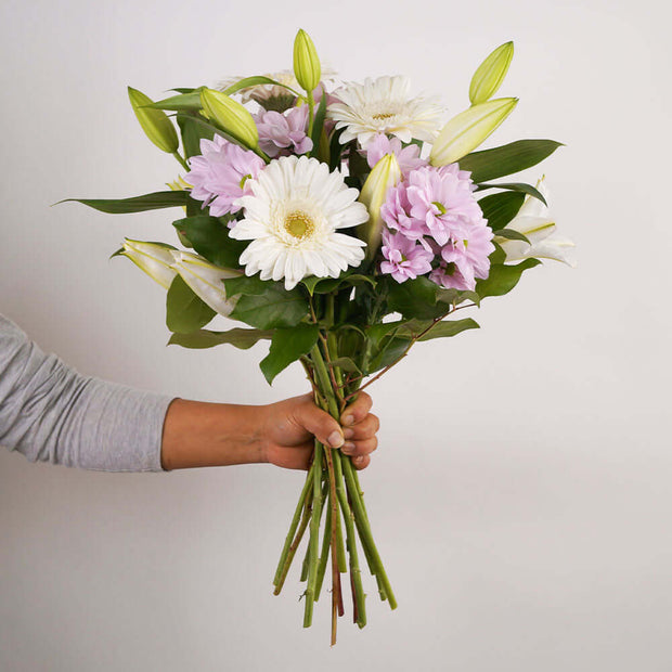 Featuring delicate oriental lilies surrounded by soft pink chrysanthemums and cheerful gerbera daisies, this bouquet is a true expression of love and appreciation.