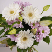 Featuring delicate oriental lilies surrounded by soft pink chrysanthemums and cheerful gerbera daisies, this bouquet is a true expression of love and appreciation.