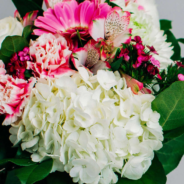 Bouquet designed with white and pink flowers.  For celebrating a birthday, anniversary, get well wishes or just because.