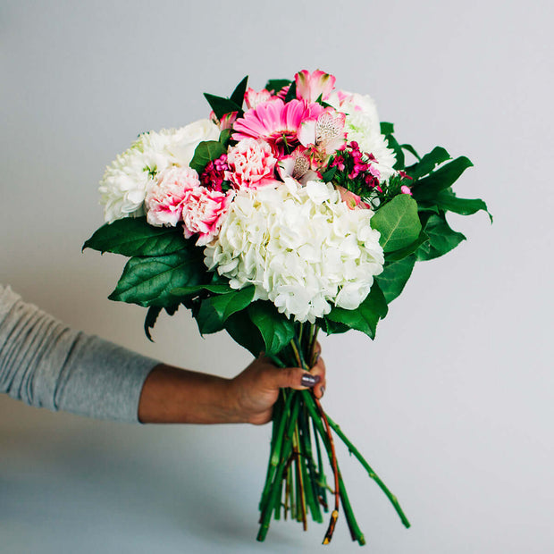Bouquet designed with white and pink flowers.  For celebrating a birthday, anniversary, get well wishes or just because.