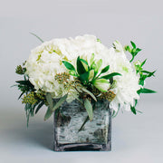 White flowers like hydrangea, rose, disbud and alstroemeria are surrounded by the nice smell of the eucalyptus. You can send your condolences to your loved ones in Port Moody with this elegant arrangement.