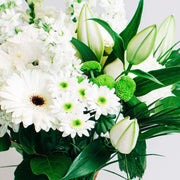 Wishing to send your sympathies and peace? This bouquet is ideal for your condolences. Designed in white and green seasonal flowers.