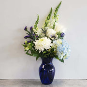 Vase arrangement in shades of blue and white captures every wish you want to express to those who mean the most