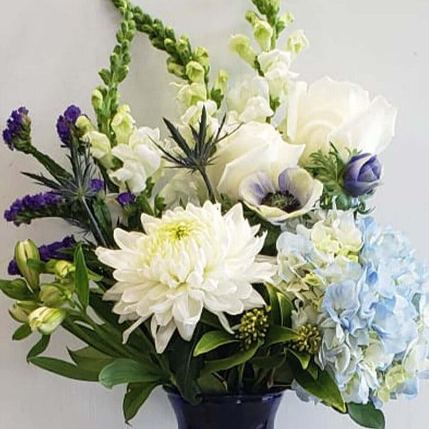 Vase arrangement in shades of blue and white captures every wish you want to express to those who mean the most. Gift idea for a newborn baby boy.