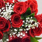 Dozen red roses in a hand-tied bouquet with filler flowers surrounded with seasonal greenery. The perfect gift to say "I love you". Our roses are of the highest quality, long stemmed and imported from Colombia and Ecuador.