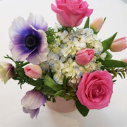 Low pink vase filled with pastel colour flowers.  Ideal for birthdays, anniversaries, baby welcomes, or those cherished 'just because' occasions