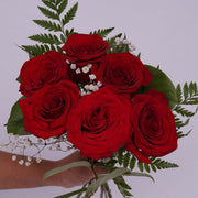 Hand-tied bouquet of six red roses. It's all about passion and love.