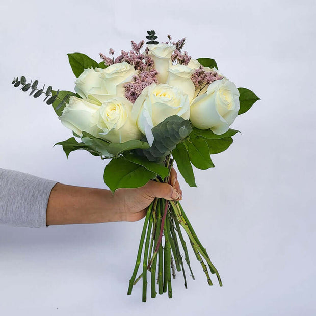 A dozen gorgeous white roses with seasonal greenery and filler flower, are the perfect romantic gift to send to the one who's always on your mind and in your heart.
