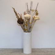 Dried flowers in white and neutral colors in a tall white vase. Perfect match for any decoration.