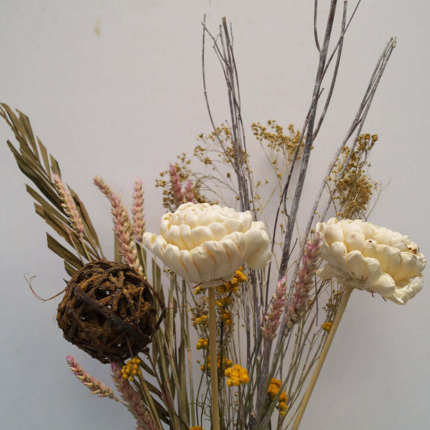 Dried flowers in white and neutral colors in a tall white vase. Perfect match for any decoration.