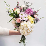 Bouquet of soft colours in pink, purple, orange, yellow and white flowers. Using hydrangea, chrysanthemums, disbuds, carnations, roses, eryngium, limonium, waxflower  and dendrobium orchid, the florist create a beautiful bouquet as the perfect gift to your loved ones 