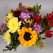 Bright and colorful short blooms arranged in a cube low vase.